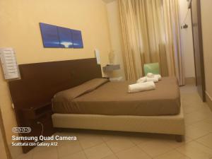Posteľ alebo postele v izbe v ubytovaní Hotel Villa Ionia