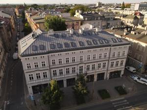 an overhead view of a white building in a city at PLANTONIA Aparthotel in Kraków
