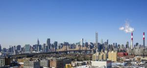 a view of a city with a bridge and buildings at Boro Hotel in Queens