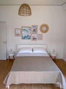 a bedroom with a large bed and two tables at Chez Lina - Appartamento Marina in Trapani