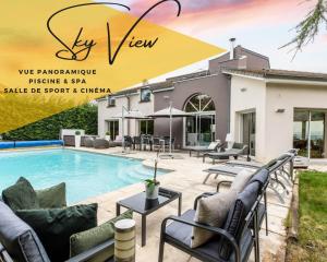 a villa with a swimming pool and patio furniture at Sky view cinema, piscine, Spa in Ceyrat