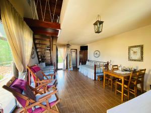 a living room with a bed and a table and chairs at Villa La dame blanche in Skala Potamias