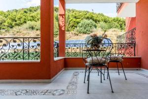 a balcony with two chairs and a table with a view at Hotel Cvita in Split