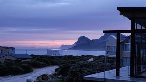 a house with a view of the ocean and mountains at Suikerbos in Pringle in Pringle Bay