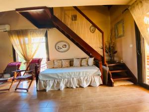 a bedroom with a bed in a room with a staircase at Villa La dame blanche in Skala Potamias
