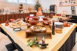 a buffet line with food on a table at Hotel Cvita in Split