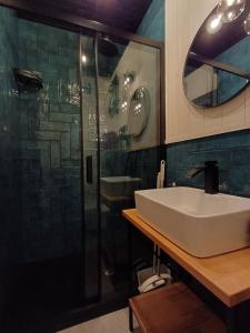 a bathroom with a sink and a shower at Apartamenty być morze in Krynica Morska