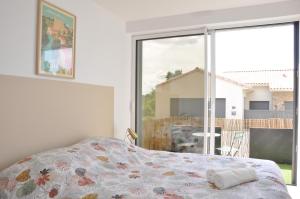 a bedroom with a bed and a large window at gîte du Cellier nantais in Le Cellier