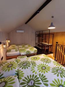 a bedroom with three beds with green and white sheets at Apartamenty być morze in Krynica Morska