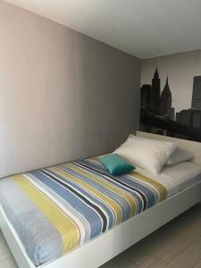 a bed in a bedroom with a city skyline at Sea Margarita Apartment in Pag