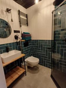 a bathroom with a toilet and a sink and a shower at Apartamenty być morze in Krynica Morska +61 photos