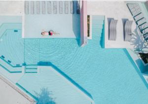 an overhead view of a person swimming in a swimming pool at SYN Boutique Hotel in Chiang Mai