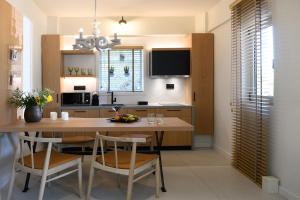 a kitchen with a table and chairs and a dining room at Domes of Elounda, Autograph Collection in Elounda