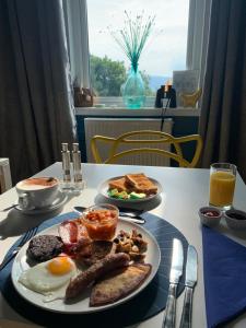 a table with two plates of breakfast food on it at Burnbank BnB in Tobermory