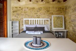 a bedroom with a bed and a table at Maria's cottage house in Aïtánia