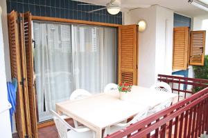 a white table and chairs on a balcony at Playazul seafront apartament in Cambrils