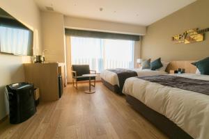 Una cama o camas en una habitación de Spa & Hotel Suishun Matsuiyamate