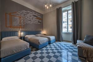 two beds in a room with a wall with words on it at The Pope's Window in Rome