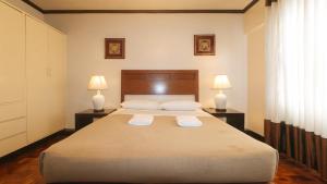 Ένα ή περισσότερα κρεβάτια σε δωμάτιο στο El Rico Suite Makati by RedDoorz