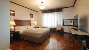 Ένα ή περισσότερα κρεβάτια σε δωμάτιο στο El Rico Suite Makati by RedDoorz
