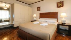 Ένα ή περισσότερα κρεβάτια σε δωμάτιο στο El Rico Suite Makati by RedDoorz