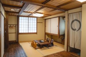 uma sala de estar com uma mesa e cadeiras em Kyo no Yado Sangen Ninenzaka em Quioto