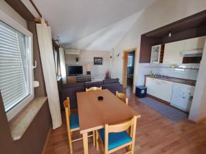 a kitchen and dining room with a table and chairs at Apartments Lucia in Medulin