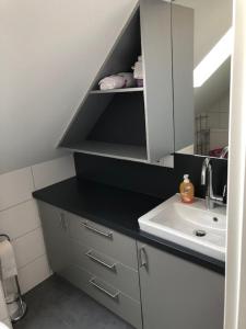 a small kitchen with a sink and a counter top at WeinMotel Simon 1 a in Alzenau in Unterfranken