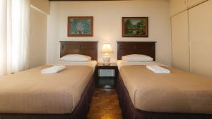 Ένα ή περισσότερα κρεβάτια σε δωμάτιο στο El Rico Suite Makati by RedDoorz