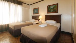 Ένα ή περισσότερα κρεβάτια σε δωμάτιο στο El Rico Suite Makati by RedDoorz