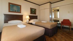 Ένα ή περισσότερα κρεβάτια σε δωμάτιο στο El Rico Suite Makati by RedDoorz