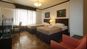 Ένα ή περισσότερα κρεβάτια σε δωμάτιο στο El Rico Suite Makati by RedDoorz