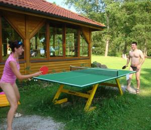 un hombre y una mujer jugando al ping pong en Appartement Camping Paradijs, en Zlatá Koruna