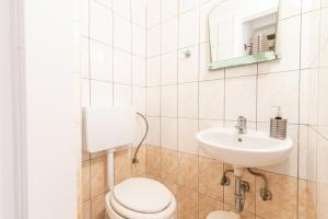 a bathroom with a toilet and a sink at House with Pool & Garden for Families & Friends 2 in Heraklio Town