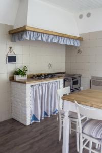 a kitchen with a table and a table and chairs at B&B Arco Di Pietra in Quinto di Treviso