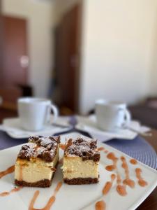 a plate with two pieces of cake on a table at Villa Molo in Rewal