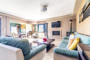 a living room with two couches and a fireplace at House with Pool & Garden for Families & Friends 1 in Heraklio Town