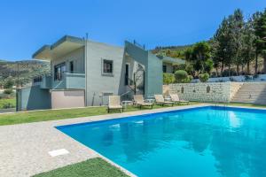 a swimming pool in front of a house at House with Pool & Garden for Families & Friends 1 in Heraklio Town