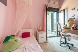a bedroom with pink walls and a bed with a teddy bear at House with Pool & Garden for Families & Friends 1 in Heraklio Town +56 photos