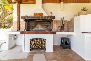a fireplace in a kitchen with a stove at House with Pool & Garden for Families & Friends 2 in Heraklio Town