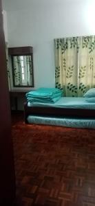 een bed met blauwe kussens in een kamer bij Pretty Bear Homestay in Cameron Highlands