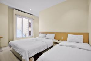 Кровать или кровати в номере Vivostay