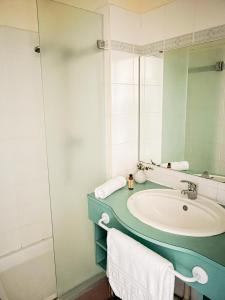 a bathroom with a sink and a mirror at VVF Narbonne-Plage Saint-Pierre-la-Mer in Fleury
