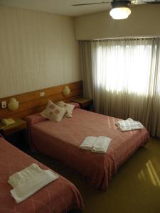 A bed or beds in a room at Hotel El Velero