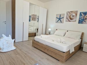 Кровать или кровати в номере LT VISTA MARE -Baia Verde- Gallipoli