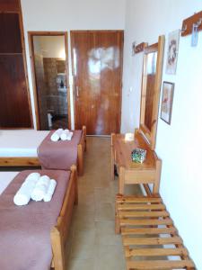 a small room with two beds and a table at Loggia Two in Agia Galini