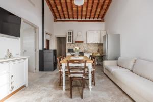 a kitchen and dining room with a table and a couch at Anita in Colle di Val d'Elsa