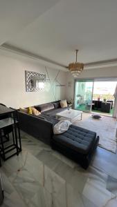 a large living room with a couch and a table at La siesta vue sur mer in Mohammedia