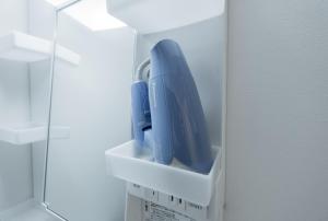 a blue hairdryer in a white box in a refrigerator at Niseko Hirafu Ski Resort Condo in Kutchan