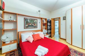 a bedroom with a red bed with two pillows at Pescara Colli Roomy Apartment with parking in Pescara